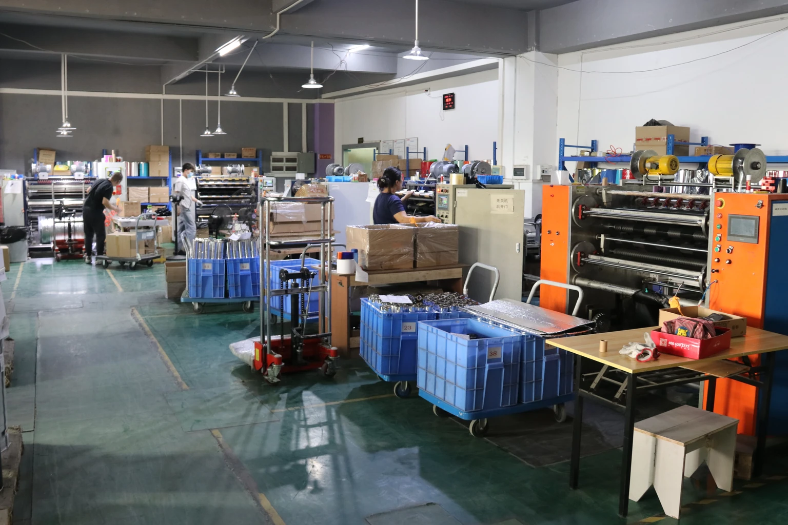 Wide view of ribbon-converting equipment and operators