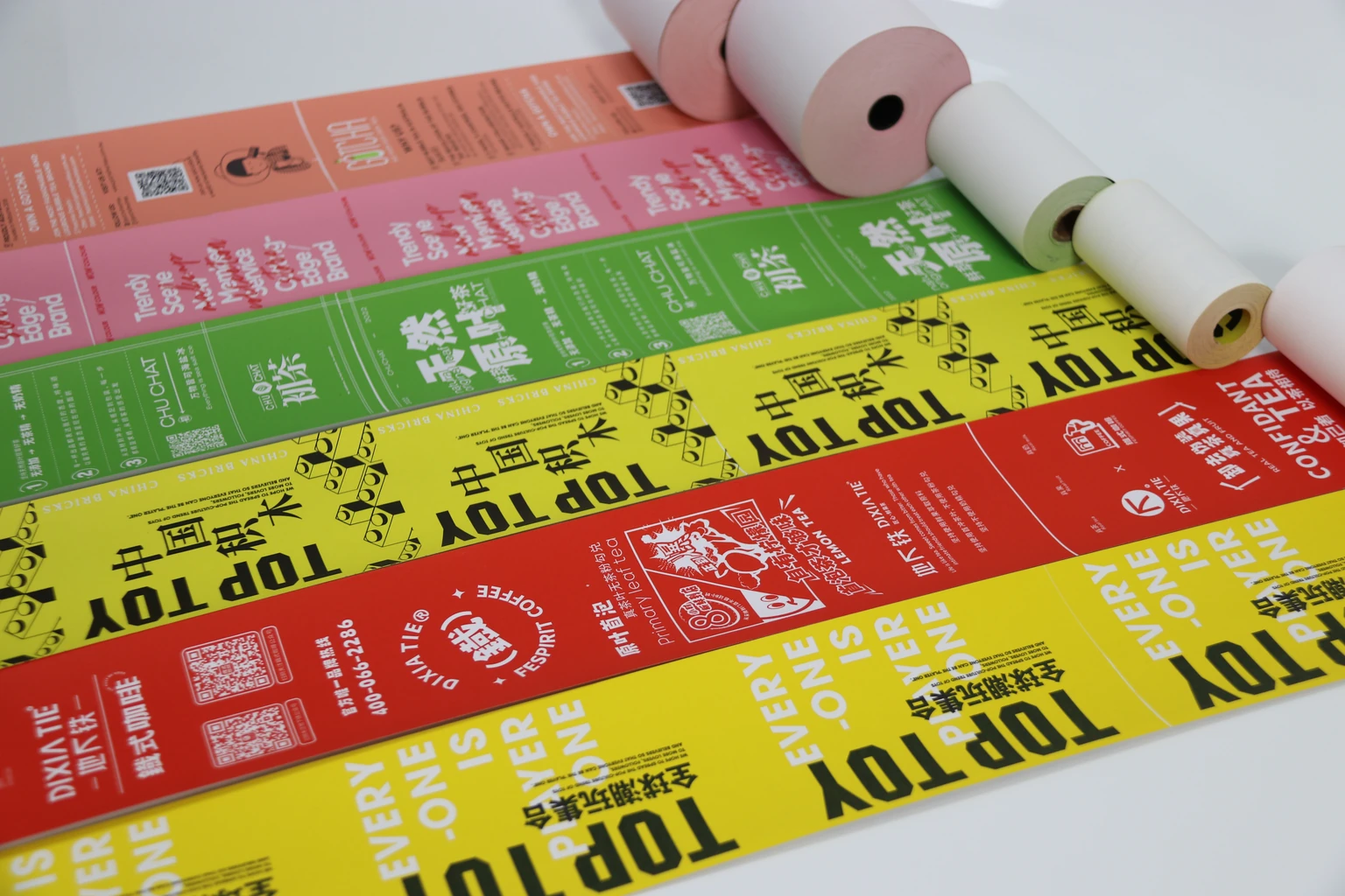 Parallel unrolled printed paper samples with different repeating artwork