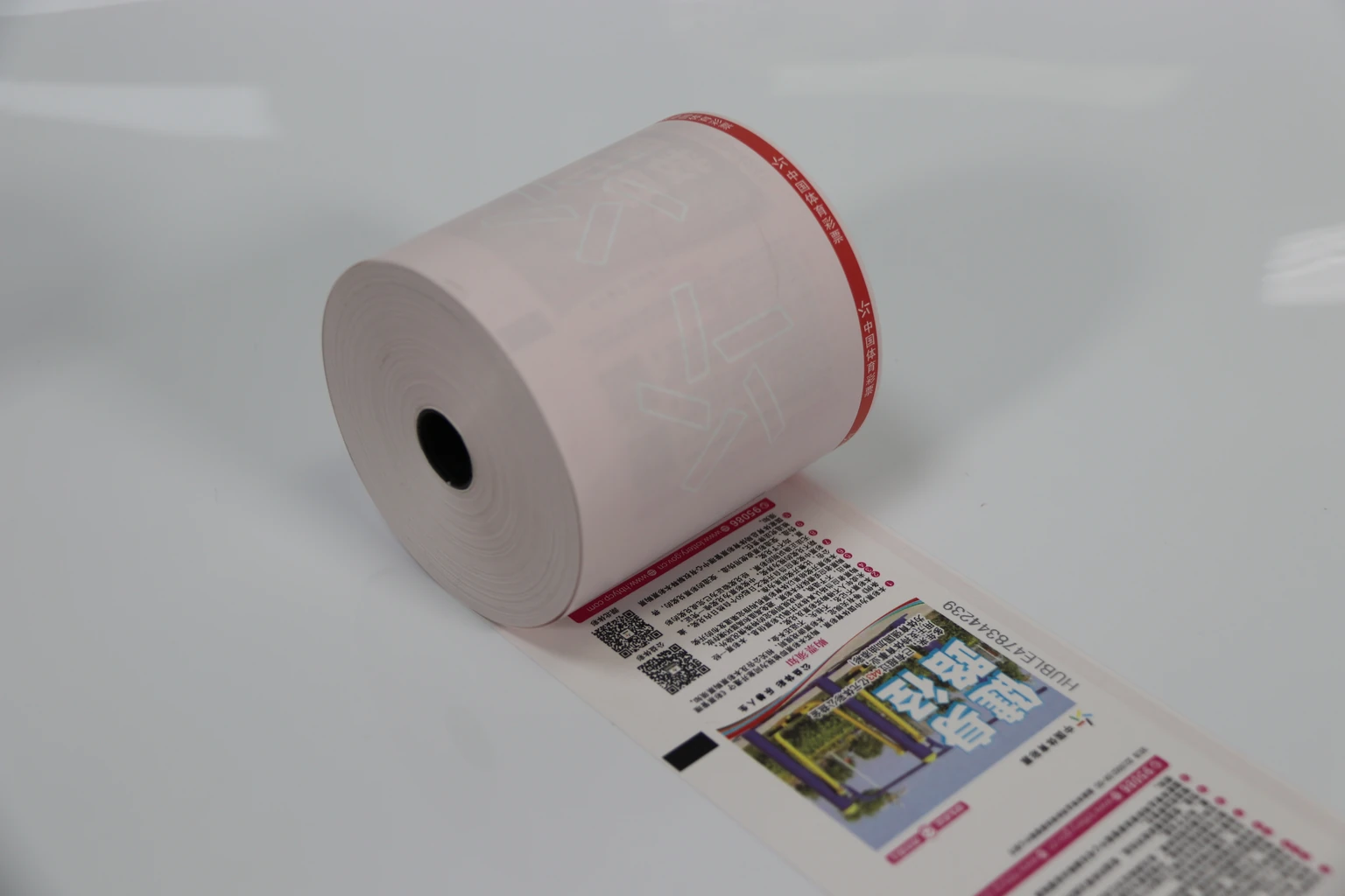 A preprinted ticket-paper roll unrolled to show artwork and registration marks