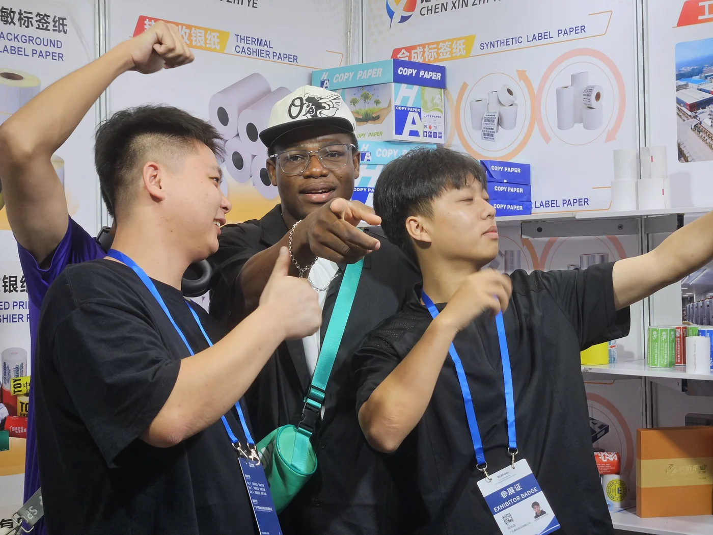 A candid interaction between people at the exhibition stand