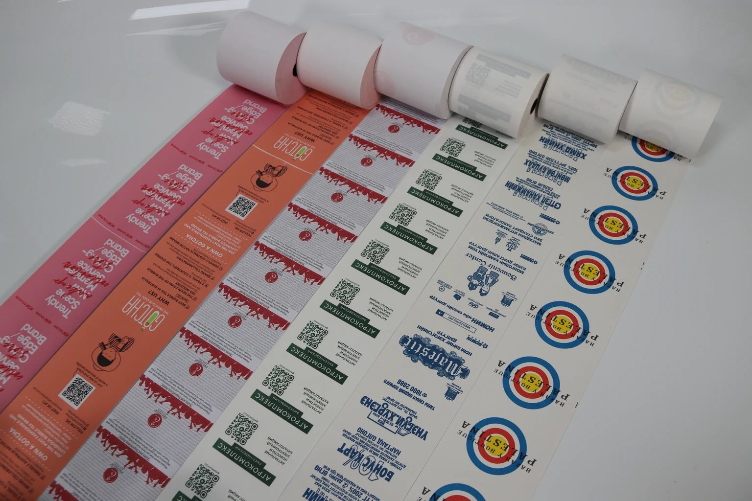 Client printed receipt-paper samples showing different artwork layouts