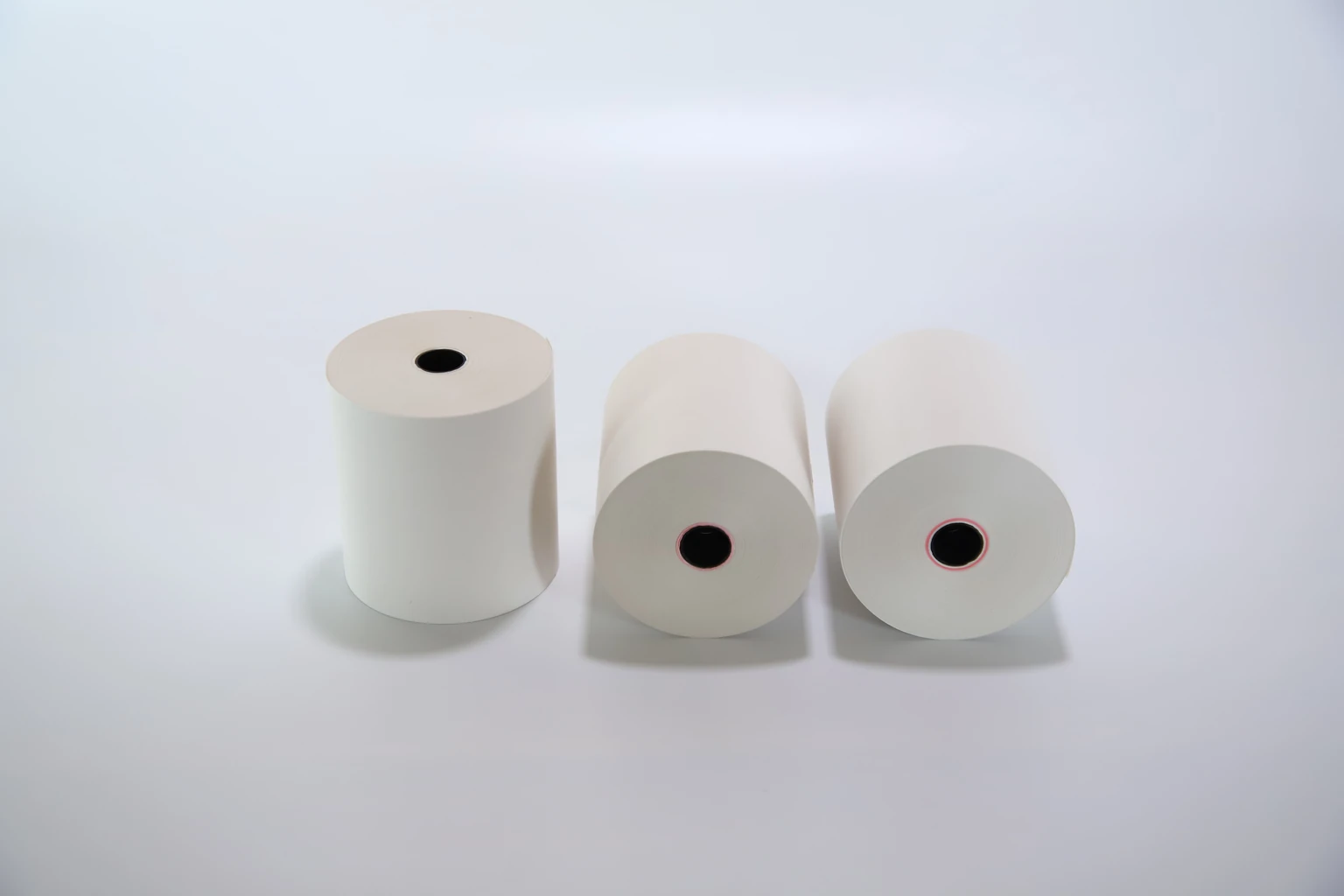 Three receipt-paper rolls showing the roll profile and core openings